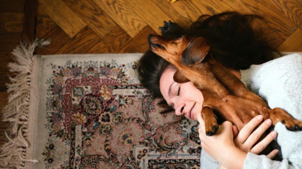 dog and woman cuddling