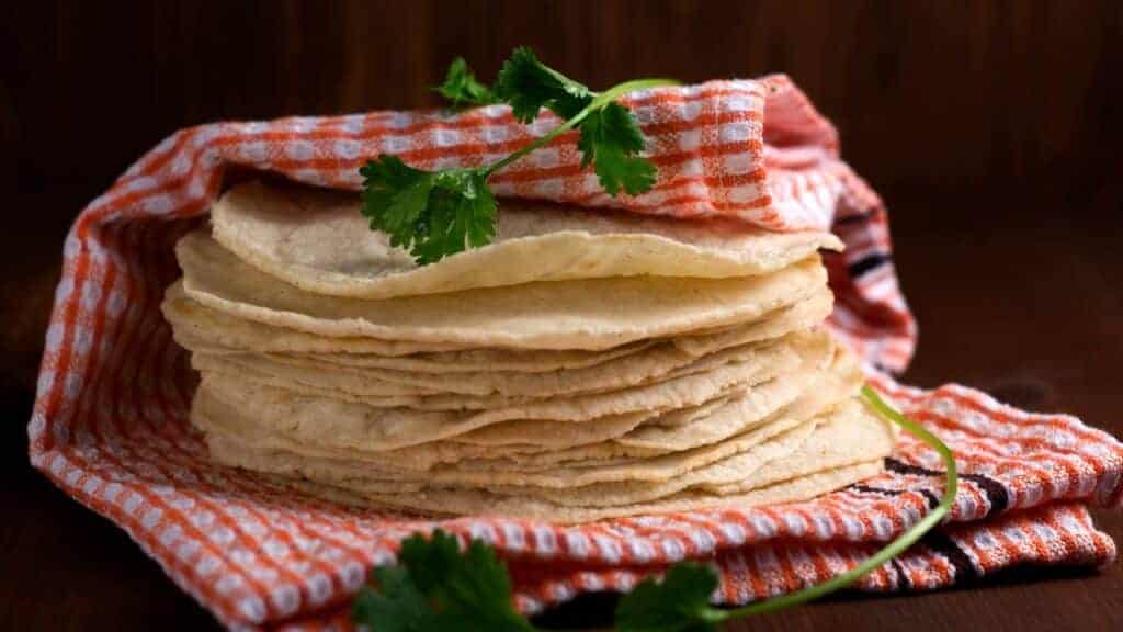 many tortillas with a towel over it