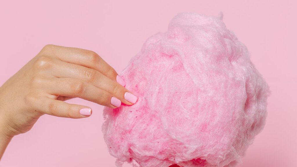 hand taking from pink cotton candy