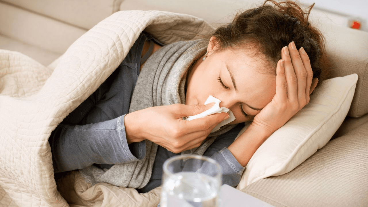 woman laying in bed sick